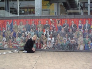 Genene in front of the Mural at Docklands